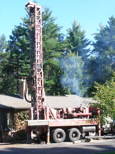 Drill rig with mast raised, drilling has begun