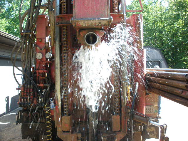 Water gushing out of the casing — water table reached