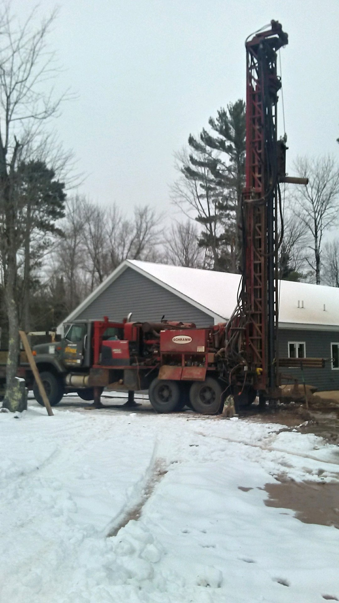 Jelinek's red Schramm drill rig at a Northern Wisconsin home