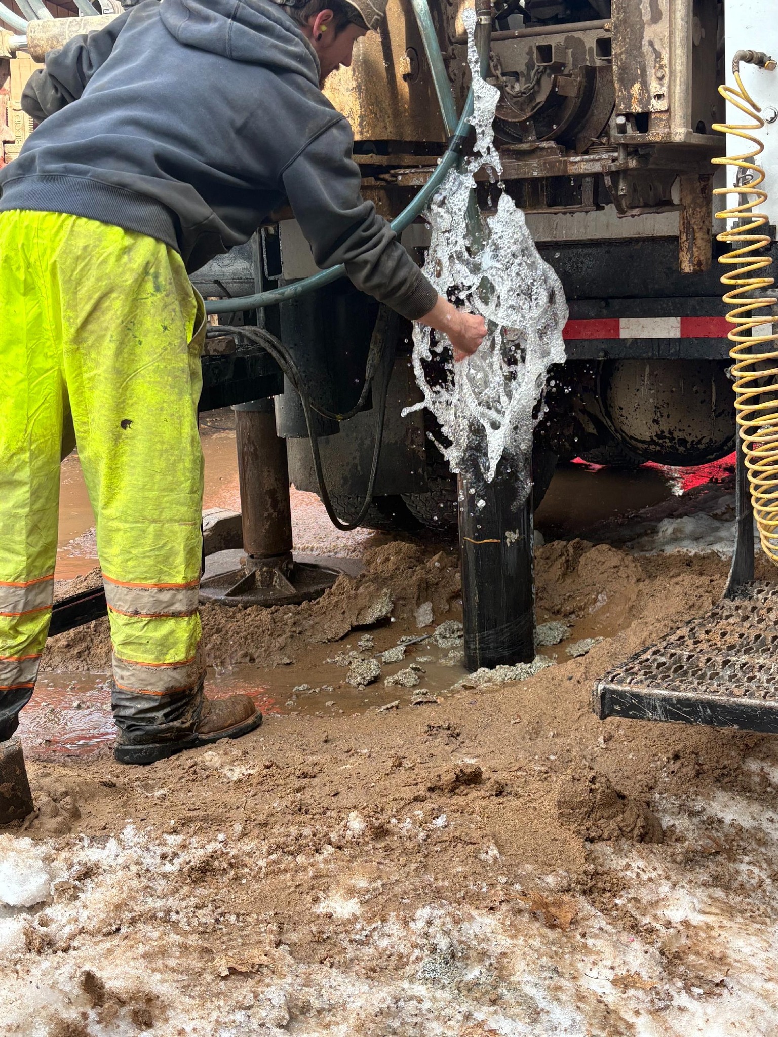 Water flowing from the well casing as Jelinek crew completes a drilling job